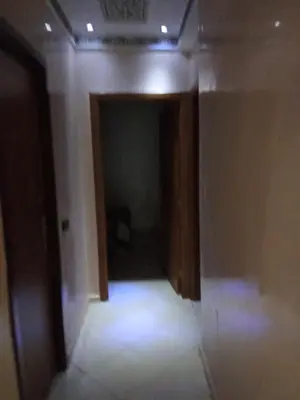 a hallway with a room with a door and lights at شقة بغرفتين نوم لك بالكامل in Marrakech