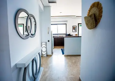 a laundry room with a sink and a mirror at Appartement moderne Guéliz, Centre Marrakech in Marrakech