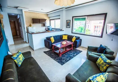 a living room with couches and a table at Appartement moderne Guéliz, Centre Marrakech in Marrakech