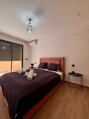 a bedroom with a large bed with a red headboard at Nice apartment in Marrakesh in Marrakech