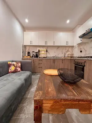 a living room with a couch and a wooden table at Nice apartment in Marrakesh in Marrakech