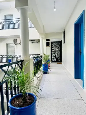 a front porch of a house with a blue door at Luxury Studios with Balcony in Marrakech
