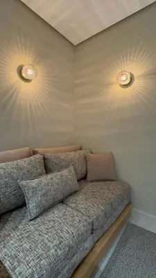 two lights on the wall above a couch in a room at Luxury Studios with Balcony in Marrakech