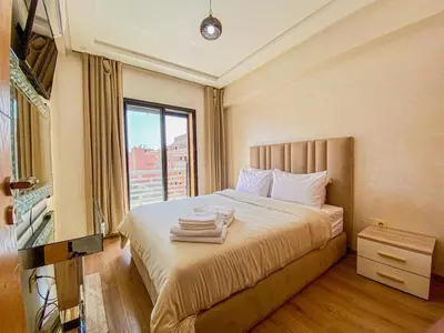 a hotel room with a bed with towels on it at Opera hivernage in Marrakech