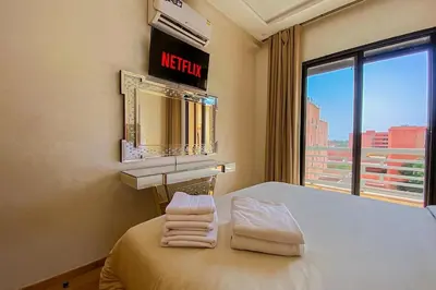 a room with a bed with a mirror and a window at Opera hivernage in Marrakech
