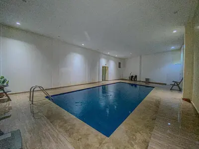 a large swimming pool in a large room with at Opera hivernage in Marrakech