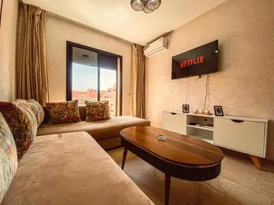 a living room with a couch and a table at Opera hivernage in Marrakech