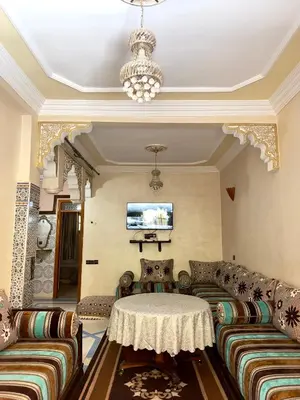 a living room with couches and a table at Cozy Garden Home in Marrakech in Marrakech