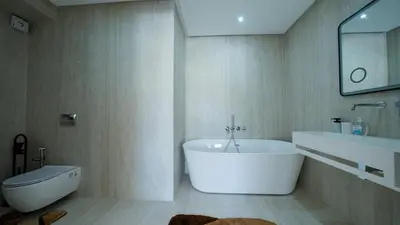 a bathroom with a tub and a sink and a toilet at Villa Adam in Oulad Akkou