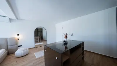 a living room with a table and a couch at Villa Adam in Oulad Akkou