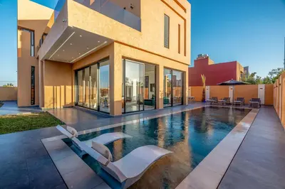 a swimming pool in the middle of a house at Villa iganis & Spa Marrakech in Marrakech