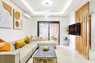 a living room with a couch and a table at Gueliz Comfort Corner Urban Apt in Marrakech