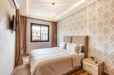 a bedroom with a bed and a window at Gueliz Stay modern apt in Marrakech
