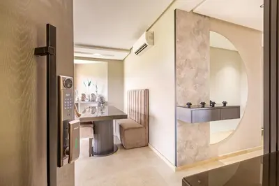 a hallway with a table and a mirror at Luxurious 3BR by to the pool in Marrakech