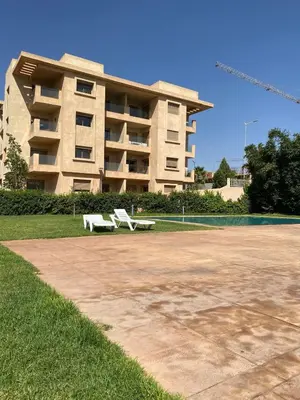a white bench sitting in front of a building at Luxury apartment with 2 pools in Marrakech