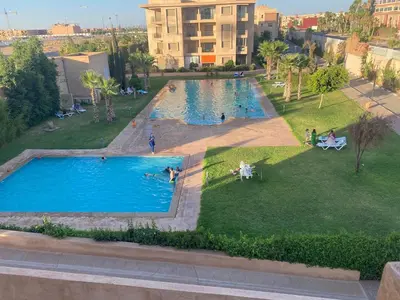 an overhead view of a large swimming pool in a park at Luxury apartment with 2 pools in Marrakech
