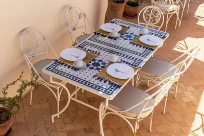 a blue and white table and chairs in a room at Riad Dar Ben Slimane in Marrakech