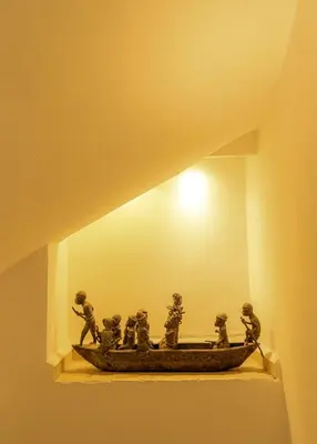 a statue of people in a boat on a shelf at Riad Dar Ben Slimane in Marrakech