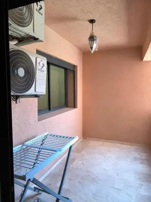 a room with a fan and a table in it at Nour Prestige in Marrakech