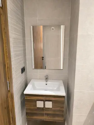 a bathroom with a sink and a mirror at Nour Prestige in Marrakech
