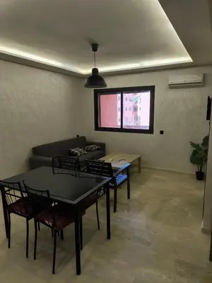 a living room with a couch and tables and a window at Nour Prestige in Marrakech