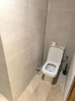 a bathroom with a white toilet in a stall at Nour Prestige in Marrakech