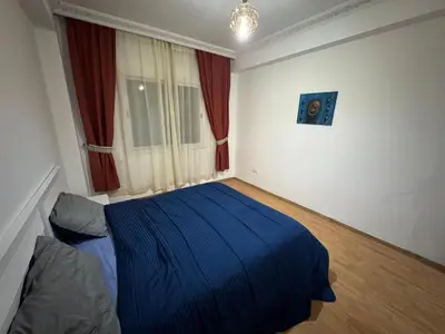 a bedroom with a blue bed and a window at Modern One Bedroom Apartment in Central Gueliz Marrakech in Marrakech
