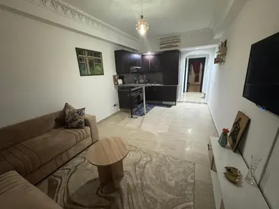 a living room with a couch and a table at Modern One Bedroom Apartment in Central Gueliz Marrakech in Marrakech