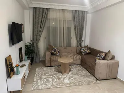 a living room with a couch and a table at Modern One Bedroom Apartment in Central Gueliz Marrakech in Marrakech