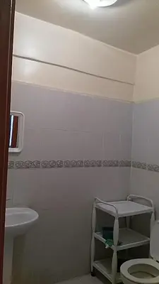 a white bathroom with a toilet and a sink at Marrakech Allal El Fassi in Marrakech