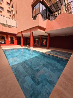 a swimming pool in the middle of a building at Appartement confortable et propre in Marrakech