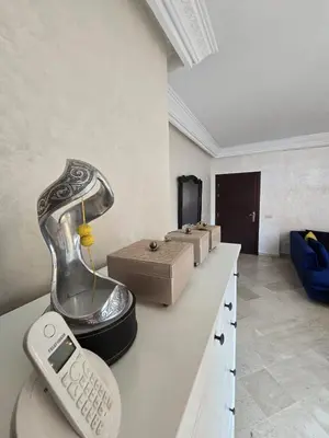 a table with a phone on it in a room at Appartement confortable et propre in Marrakech