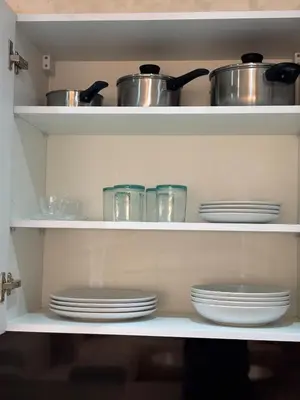 a shelf with dishes and pots and pans in a kitchen at Majorelle Retreat - Luxury Studio in Marrakech