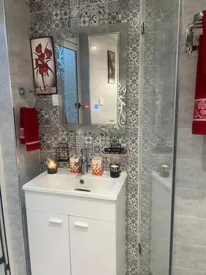 a bathroom with a white sink and a mirror at Cozy Flat near Gueliz in Center in Marrakech