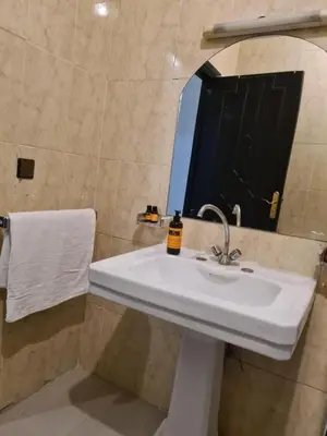 a bathroom with a white sink and a mirror at Hotel Apart LRB in Marrakech