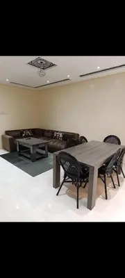 a living room with a couch and a table and chairs at Chambre Marrakech 4 in Marrakech