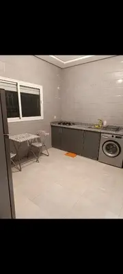 a kitchen with a stove and a washing machine at Chambre Marrakech 4 in Marrakech