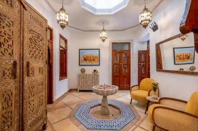 a living room with a large wooden door at Riad du Rabbin in Marrakech
