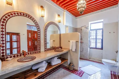 a bathroom with two sinks and a large mirror at Riad du Rabbin in Marrakech