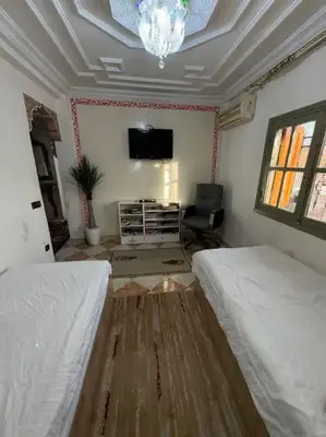 a bedroom with two beds and a flat screen tv at Appartement 