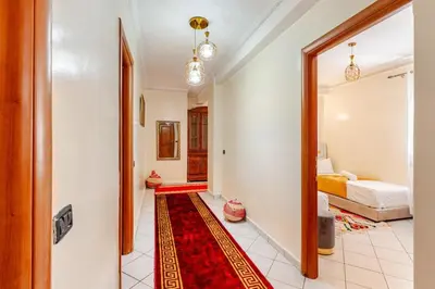 a hallway with a room with a bed and a red rug at Guéliz Marrakech 2,central, spacieux, Authentique in Marrakech