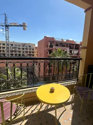 a yellow table and chairs on a balcony at apartment in the center of Guéliz in Marrakech