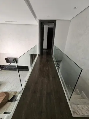 a hallway of a house with glass and wood floors at Loft confort, lumineux, avec accès piscine dans une résidence sécurisée in Marrakech