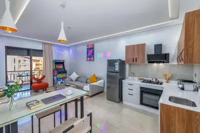 a kitchen and living room with a table and a couch at -New- Appartement stylé au cœur de Marrakech in Marrakech
