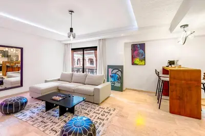 a living room with a couch and a table at Studio avec piscine et lumières d'ambiance in Marrakech