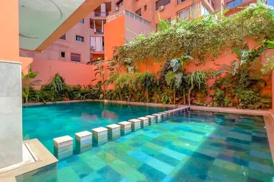 a swimming pool in front of a building at Studio avec piscine et lumières d'ambiance in Marrakech