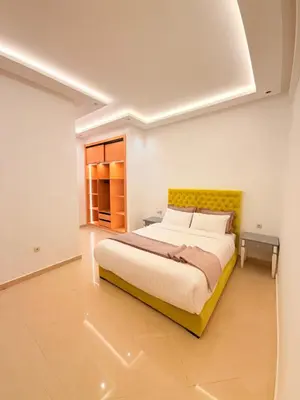 a bedroom with a large bed with a yellow headboard at Villa Patel in Marrakech