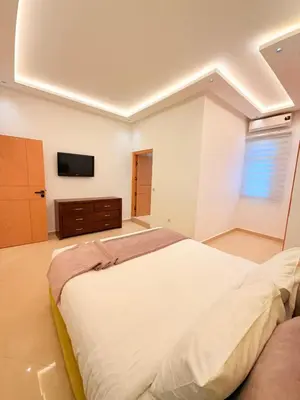 a bedroom with a large bed and a tv at Villa Patel in Marrakech