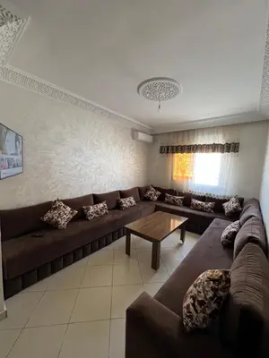 a living room with a couch and a table at Appartement Marrakech au 1er étage in Marrakech