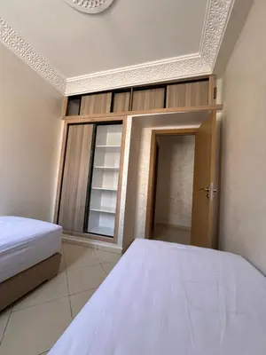 a bedroom with a bed and a window at Appartement Marrakech au 1er étage in Marrakech